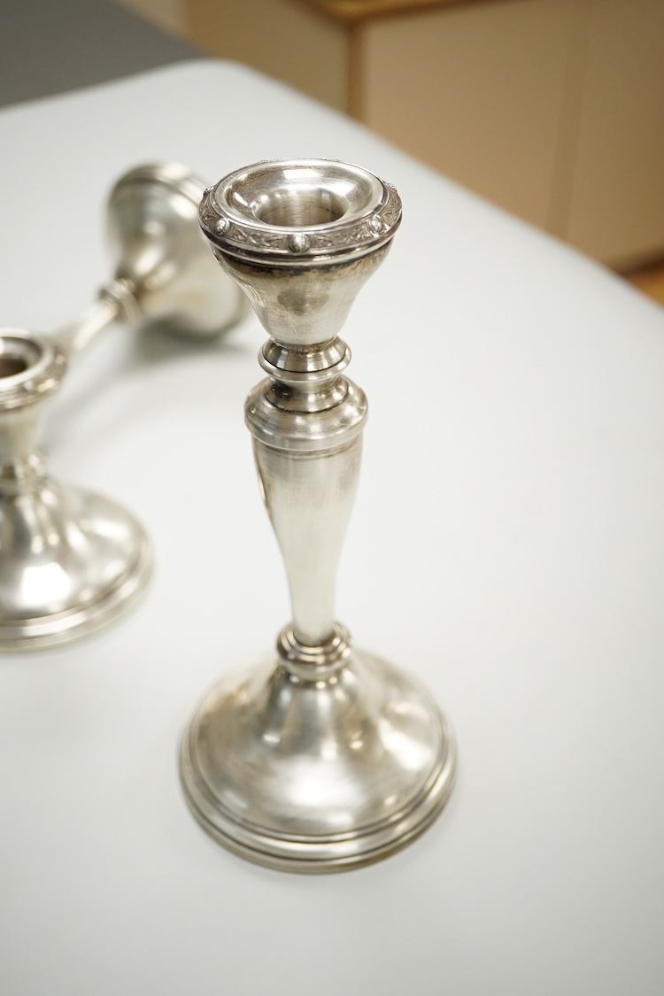 A suite of three Elizabeth II silver mounted candlesticks, comprising a pair, 20.3cm and a single dwarf candlestick, Adie Brothers, Birmingham, 1956.